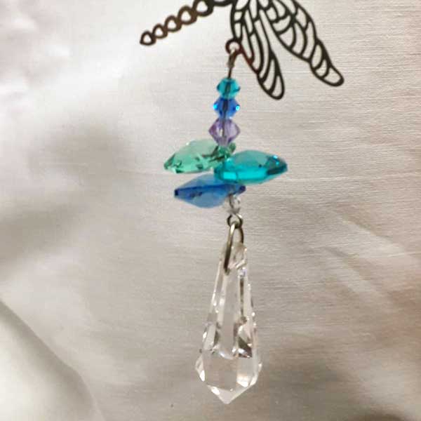 dragonfly silhouette light catcher with hanging blue and green glass crystals, bottom detail