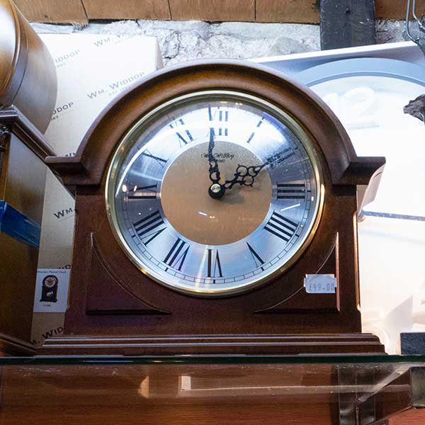 Curved mahogany clock with roman numerals £99.00